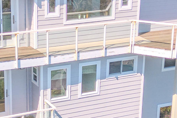 New construction home exterior in Mill Valley with Pearl Gray James Hardie siding and Arctic White trim, showcasing modern