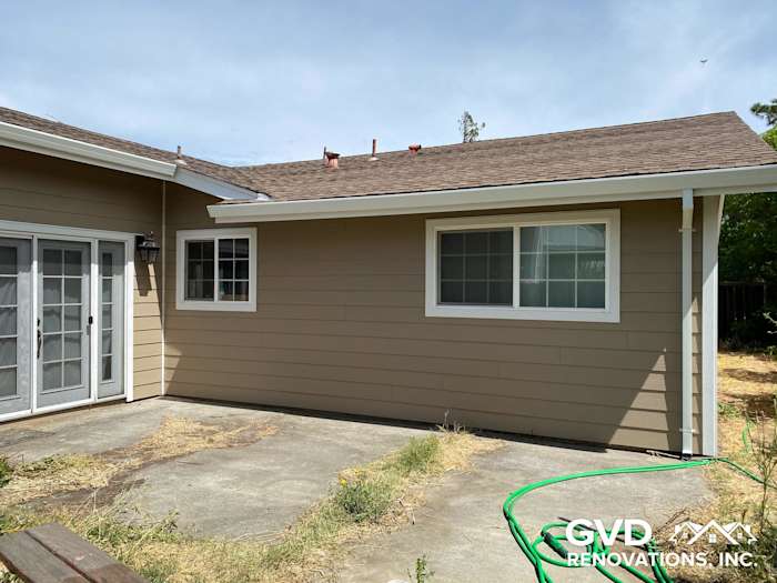 New James Hardie lap siding in Khaki Brown with Arctic White trim on Fairfield home exterior
