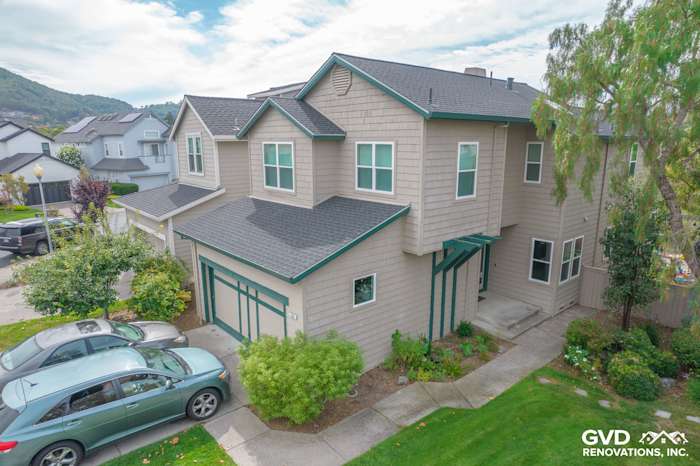 Renovated San Rafael home exterior showcasing Anlin Catalina Windows and repaired siding with green accents