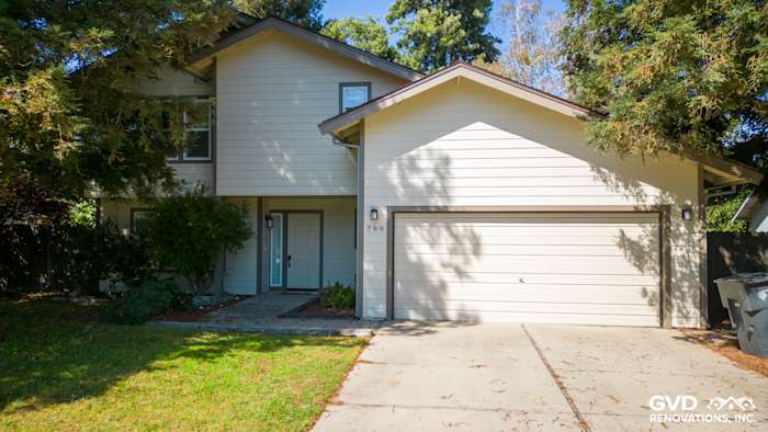 Light-colored James Hardie siding with HardieTrim on a Sacramento home, featuring a two-car garage and landscaped front yard
