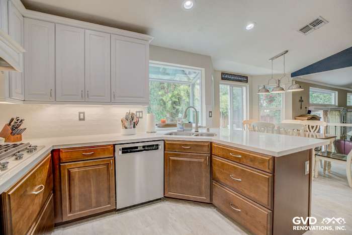 Modern kitchen with quartz countertops, dark wood cabinets, and stainless steel appliances in Elk Grove remodel