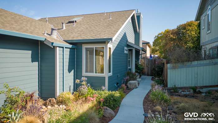 Evening Blue James Hardie Lap Siding and Cobble Stone Trim on Petaluma home exterior with landscaped walkway