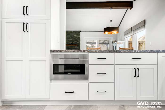 Modern Fair Oaks kitchen remodel featuring white cabinetry, sleek black hardware, and stainless steel appliances
