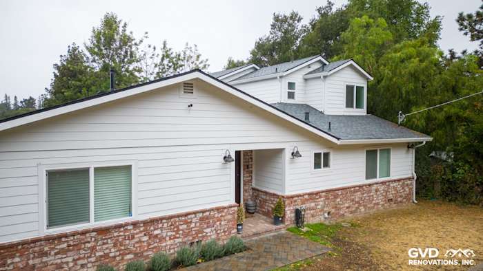 Modern Oakland home featuring James Hardie Cedarmill siding, Alside windows, and brick foundation details