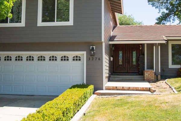 Home exterior in Pleasanton featuring Aged Pewter HardiePlank siding and Arctic White trim, with landscaped yard