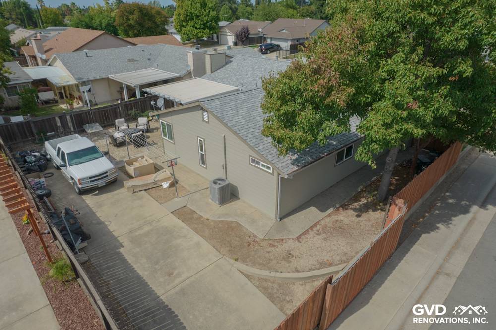 Home exterior featuring James Hardie Monterey Taupe Siding and Milgard windows, with a spacious yard in North Highlands