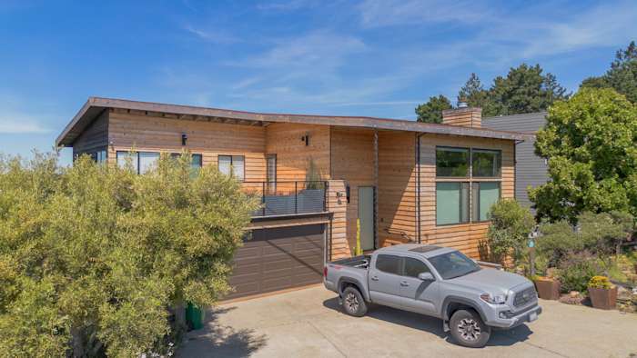 Home exterior featuring Natural Cedar Beveled Plank Siding and new deck railing in Richmond, CA