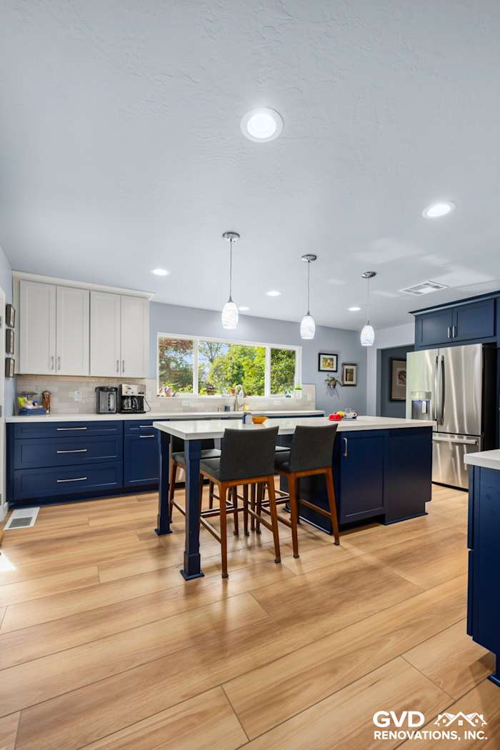 Modern kitchen remodel in Fair Oaks featuring blue cabinetry, quartz countertops, and pendant lighting