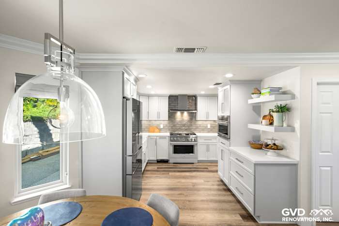 Modern kitchen remodel in Rocklin featuring sleek white cabinets, quartz countertops, and stainless steel appliances