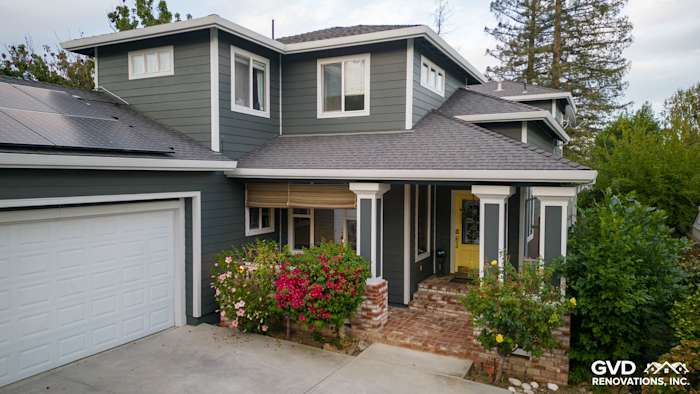 Newly remodeled home exterior featuring James Hardie Pearl Gray siding, Arctic White trim, and vibrant landscaping
