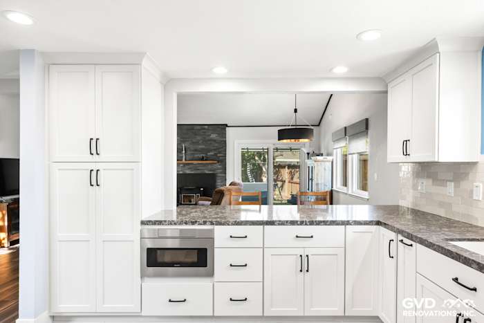 Modern kitchen remodel in Fair Oaks featuring white cabinets, granite countertops, and recessed lighting