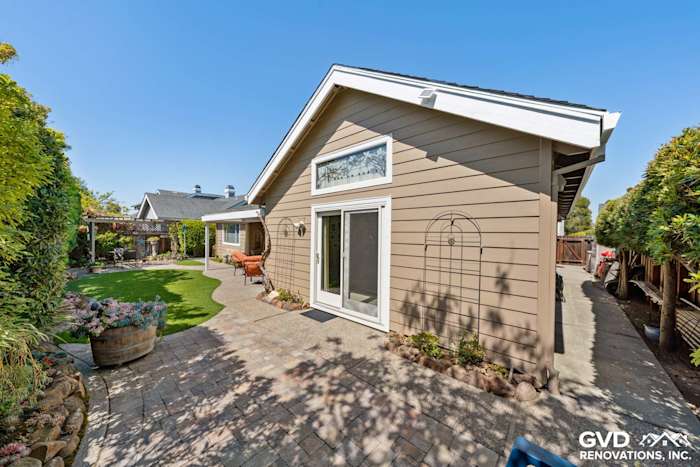 Foster City home exterior featuring Khaki Brown HardiePlank siding, Arctic White trim, and landscaped backyard