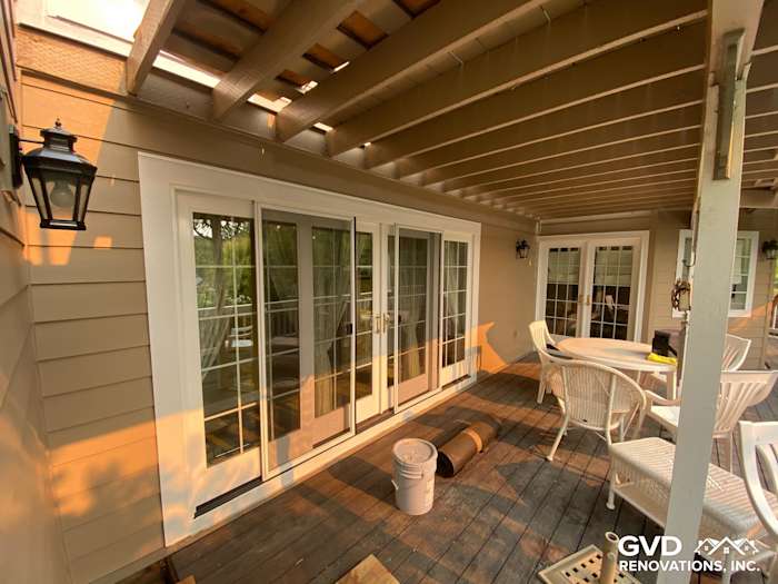 New Khaki Brown James Hardie siding alongside patio doors and deck in Petaluma home remodel