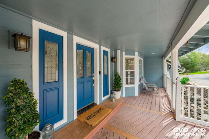 Front porch entry featuring blue James Hardie siding, double doors, and welcome mat in Shingle Springs, CA