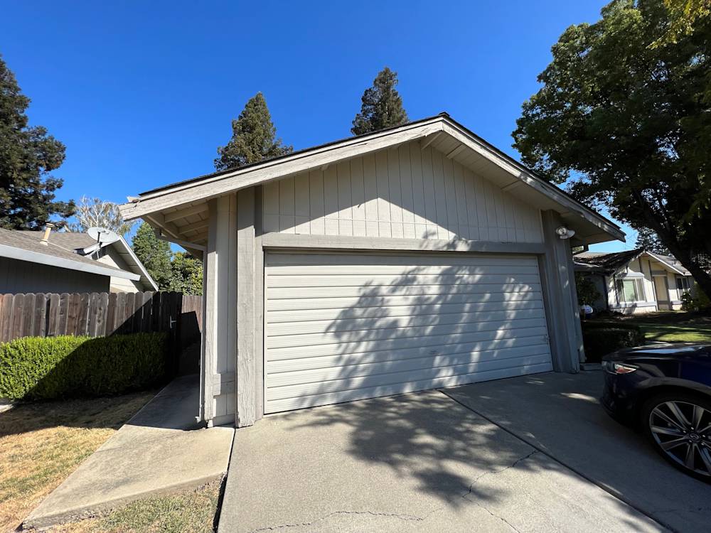 Single-story home with light gray siding and a two-car garage in Sacramento