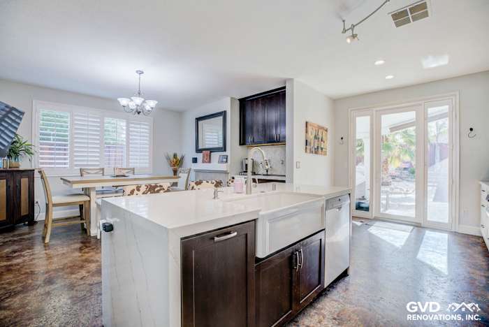 Modern kitchen remodel featuring a spacious layout, quartz island, dark wooden cabinets, and natural light from patio doors