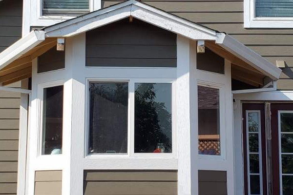 Newly installed James Hardie siding in earthy gray on a two-story Santa Rosa home with framed porch
