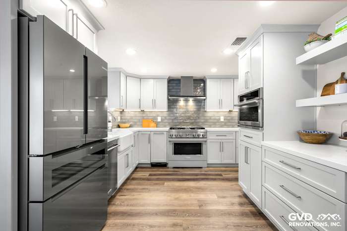 Modern Rocklin kitchen remodel featuring gray cabinetry, stainless steel appliances, and sleek wood flooring