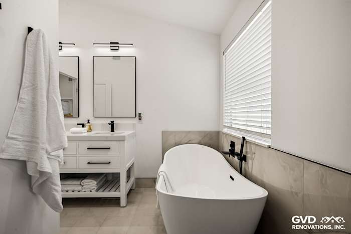 Luxurious bathroom featuring a freestanding tub, dual vanities, and stylish white decor in Antelope, CA
