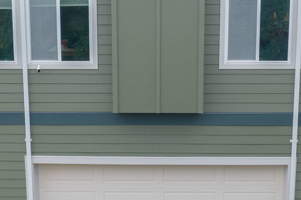Oakland home exterior featuring Mountain Sage vertical siding and CobbleStone trim with Anlin Catalina windows