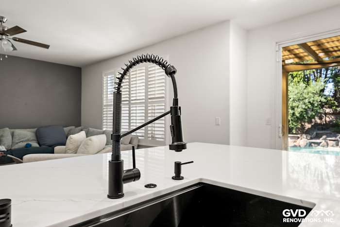 Modern kitchen sink featuring a sleek black pull-down faucet and quartz countertop in Roseville renovation