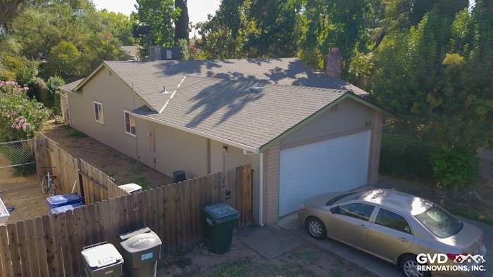 Updated home exterior featuring Monterey Taupe HardiePlank Lap Siding in Orangevale, surrounded by greenery and a paved