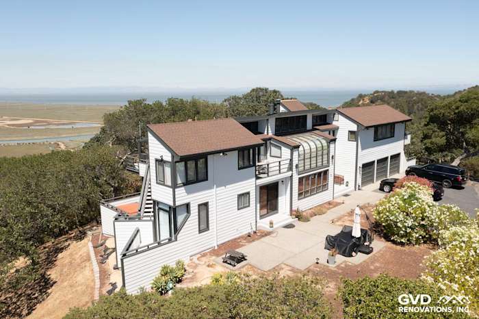 Modern home exterior in San Rafael featuring Arctic White James Hardie Lap Siding and a landscaped patio