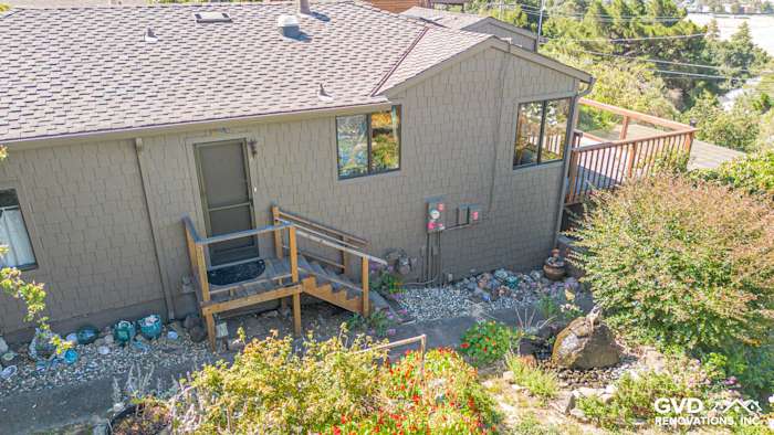 Newly installed James Hardie Shake siding on a home exterior, complemented by a wooden deck and landscaped garden in Vallejo