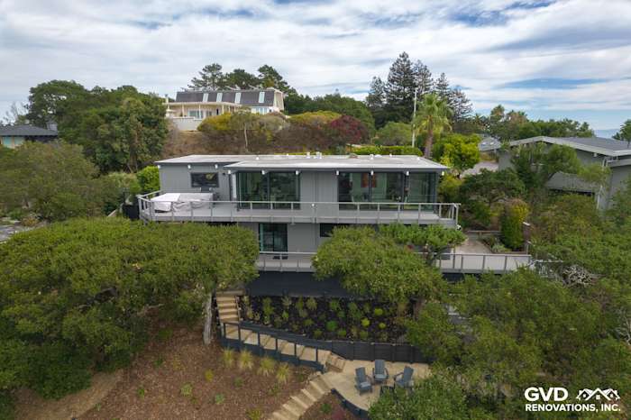 Modern home exterior in San Rafael showcasing new T1-11 siding and upgraded windows, surrounded by lush landscaping