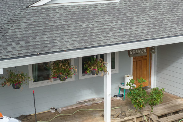 Light Mist James Hardie siding with Arctic White trim on a Sonoma home, surrounded by landscaping and mountains
