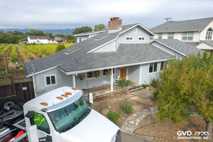 Light Mist James Hardie siding with Arctic White trim on a Sonoma home, surrounded by landscaping and mountains