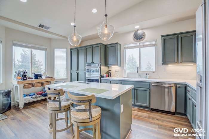 Modern kitchen in El Dorado Hills with gray cabinetry, quartz island, and pendant lighting