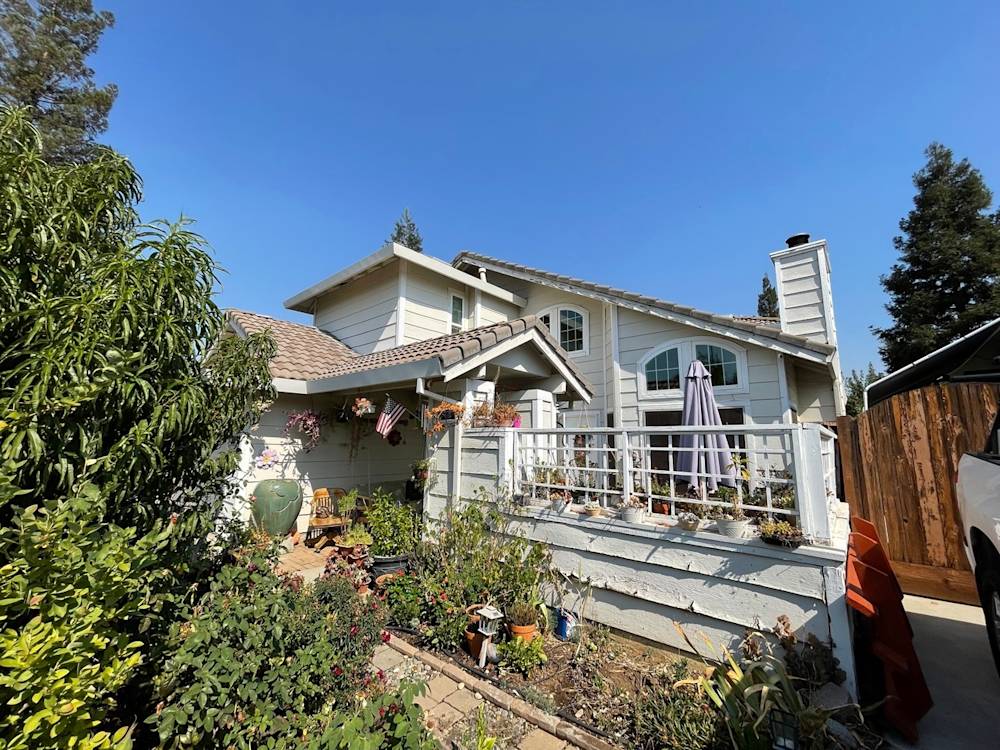 Charming two-story home in Sacramento with garden, patio, and light-colored siding
