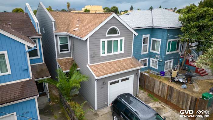 Updated Oakland home with Aged Pewter James Hardie siding, Arctic White trim, and a brown shingle roof