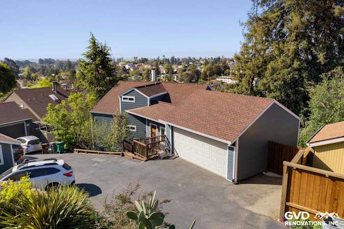 Home exterior featuring James Hardie Plank siding, new windows, and a brown shingle roof in Oakland, CA