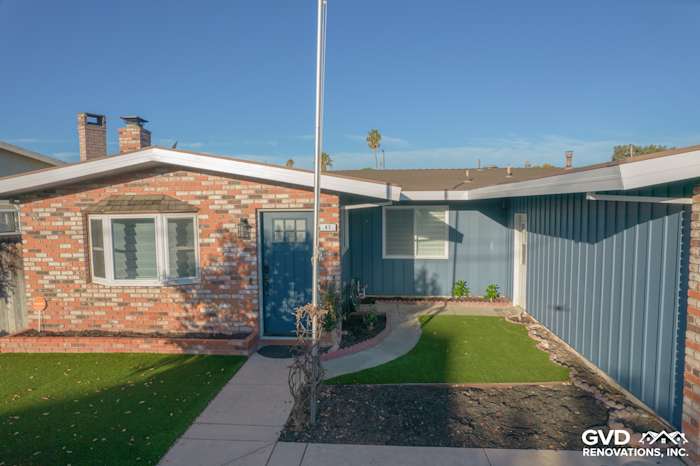 Home exterior featuring Prodigy Vinyl Siding in blue, brick details, and landscaped pathway in Antioch, CA