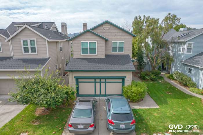 Home exterior showcasing new Anlin Catalina windows and repaired siding in San Rafael, CA, with green accents
