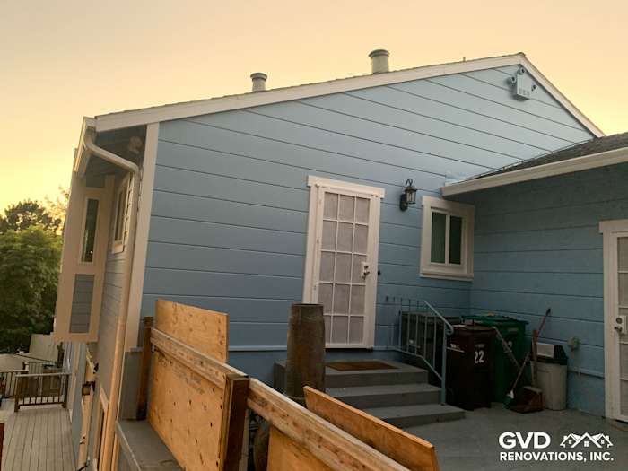 Home exterior featuring James Hardie fiber cement siding in light blue and new vinyl windows in Oakland, CA