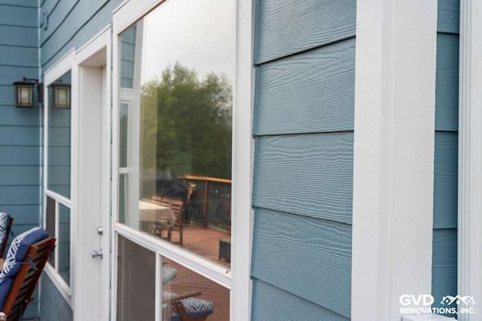Newly installed James Hardie siding in blue, showcasing smooth texture and clean lines on a home's exterior