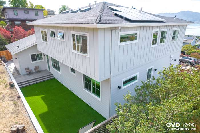 Two-story home exterior in Tiburon, featuring primed and painted Artisan Lap Siding with landscaped yard