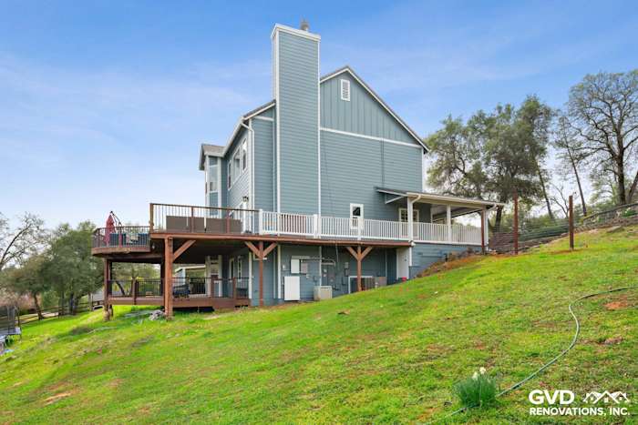 Newly installed James Hardie siding in light blue on a home exterior with a deck in Shingle Springs, CA
