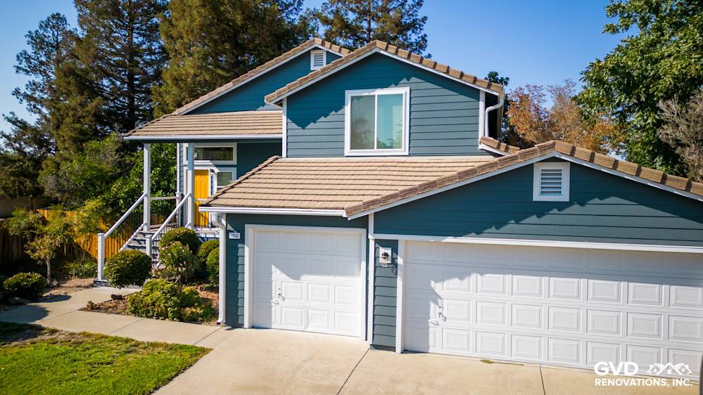 Updated home exterior featuring new blue siding, Anlin windows, and a refreshed deck in Dixon, CA
