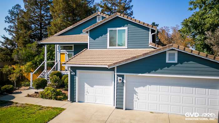 Updated home exterior featuring new blue siding, Anlin windows, and a refreshed deck in Dixon, CA