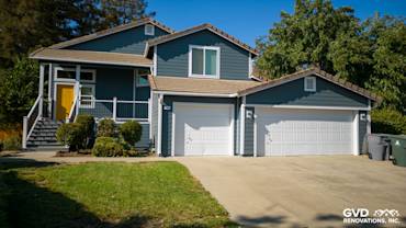 Updated home exterior in Dixon, CA with new blue siding, Anlin windows, and fresh landscaping