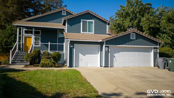 Updated home exterior in Dixon, CA with new blue siding, Anlin windows, and fresh landscaping
