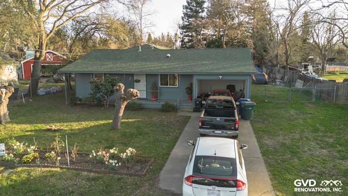 Single-story home with Boothbay Blue James Hardie siding, Anlin windows, and a driveway with parked cars