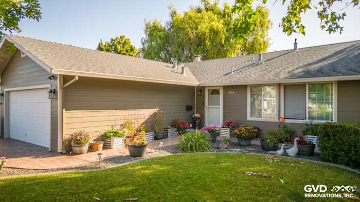 Exterior view of a Rohnert Park home featuring Timber Bark HardiePlank siding and Cobble Stone trim. Lush landscaping