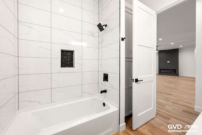 Modern bathroom featuring a sleek black bathtub, white marble tile, and stylish fixtures in Paradise, CA