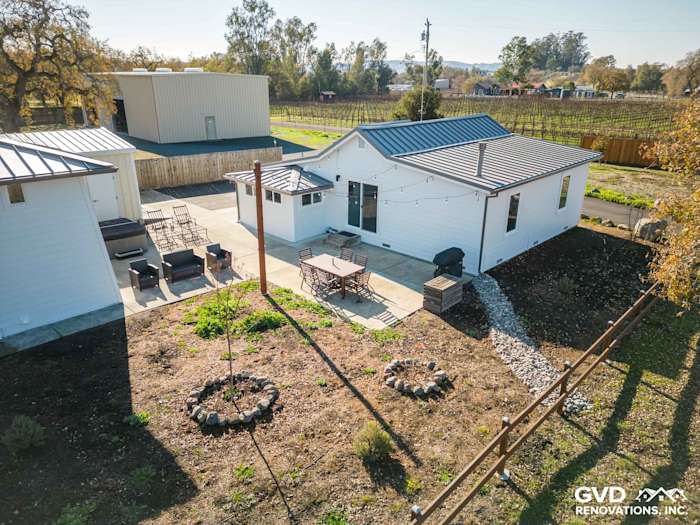 Exterior view of a Sonoma home featuring Arctic White James Hardie siding and outdoor dining area