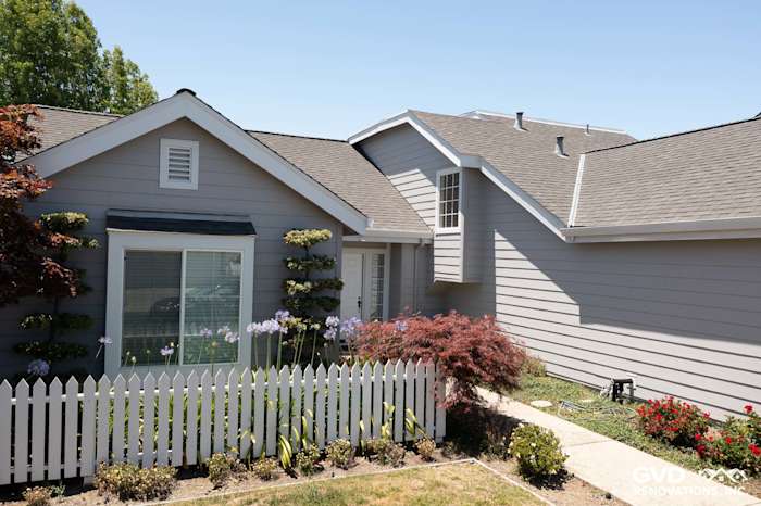 Foster City home exterior featuring Pearl Gray James Hardie siding and Arctic White trim, with landscaped yard